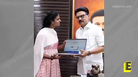 School student D Shriya receives Rs 25,000 as financial assistance and a laptop from Chief Minister M ]K Stalin 