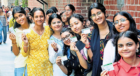 Girls, waiting in the queue to cast their vote, showing their I-Card during DUSU Election