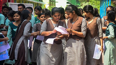 Students discuss question paper after appearing HSE Class X exam.