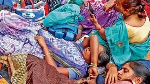 Agitating ASHA and Anganwadi workers and CITU members take a nap at Freedom Park in Bengaluru on Tuesday 