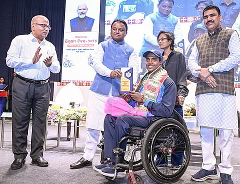 CM Mohan Charan Majhi felicitating a differently-abled youth 