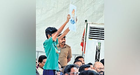 Siddharth holding a portrait of PM Narendra Modi that he drew, at the at the BJP rally