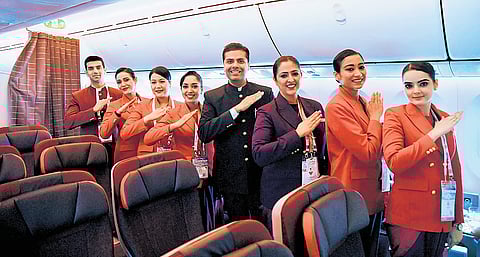 Air India staff pose for a photograph inside an aircraft during Wings India 2026 at the Begumpet Airport in Hyderabad on Thursday.