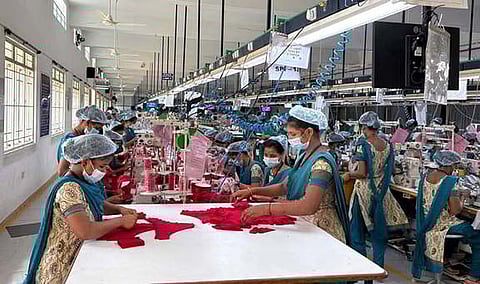 Workers engaged in production at a private knitwear manufacturing company in Tiruppur.