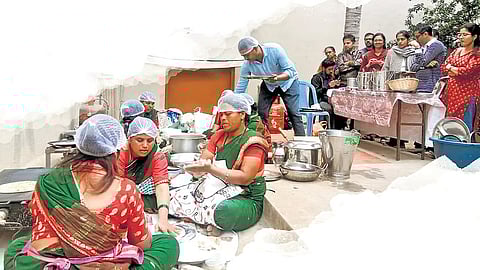 Women from Vijayapura district prepare jowar rotis during a weekly food initiative in Bengaluru