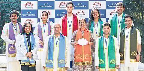 Divya Dwivedi (centre, with award), and nine gold medalists from various disciplines at the 51st convocation of IIMB on Friday Photo | Express