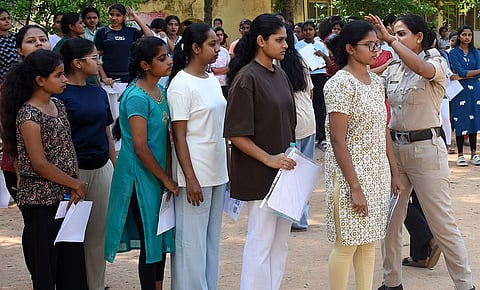 Police staff check Students with metal detectors before entering examination hall to appear for CET exam Mysuru on Thursday. 