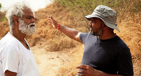 Sanjay Mishra with director Panda while shooting for Kadvi Hawa