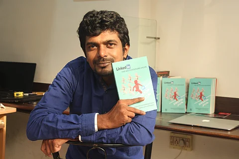 R Manickavasan with his book