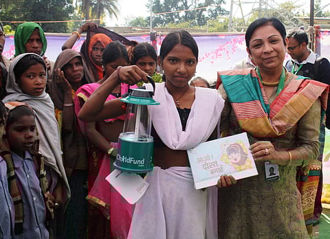 Neelam Makhijani distributing Solar lantern and story books to the underprivileged