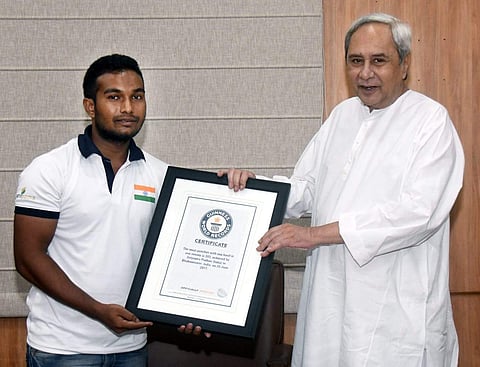 Padhan being feliicatated by CM of Odisha Naveen Patnaik