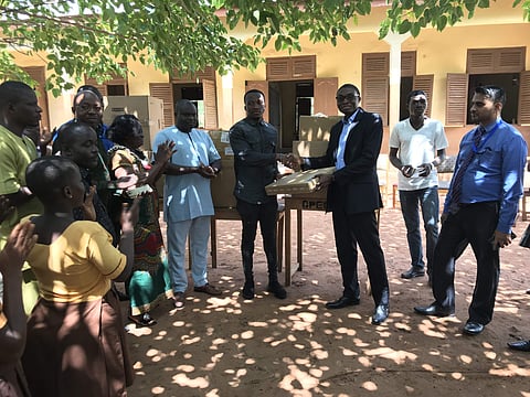 Owura Kwadwo Hottish receiving a laptop from the officer at municipal corporation
