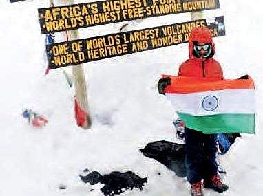 Samanyu at Uhuru peak of Mount Kilimanjaro in Tanzania, the highest peak in Africa