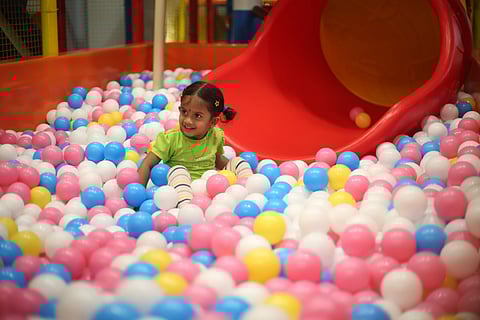 A child in the ball pen at Play2Grow