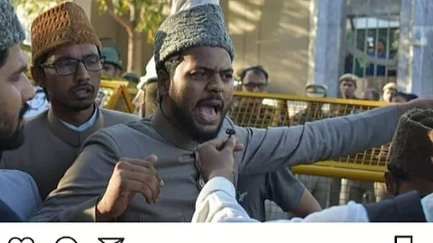 Usmani during a protest (pic: YouTube)