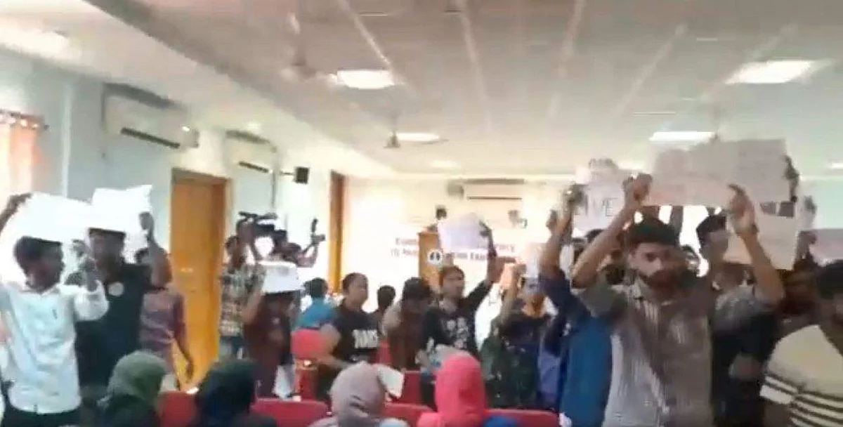 The students walking out of the auditorium
