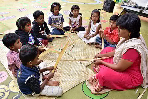 Mohana Vani M teaching students to make palm dolls (Pic: U Rakesh Kumar)
