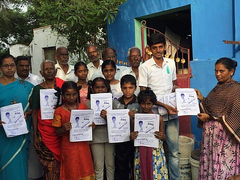 S Nagarjun distributes his pamphlets to people during the election campaign