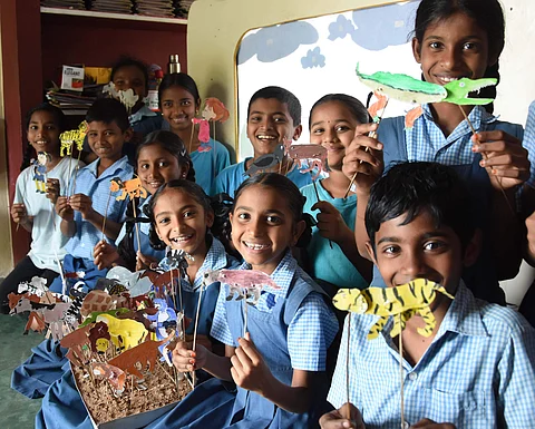 All smiles: Students holding up their stick puppets which they made at school | (Pic: RVK Rao)