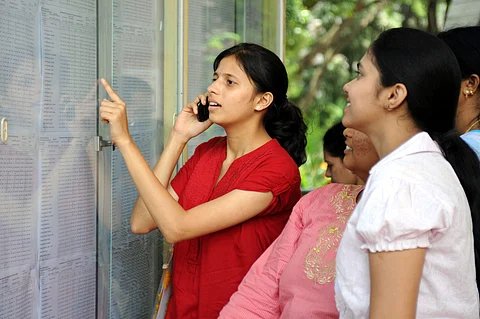 Students take a look at their results put on the notice board (Pic: Express)