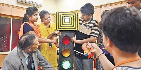 Students from Sapthagiri College of Engineering presending a censor-based traffic signal, in Bengaluru on Wednesday