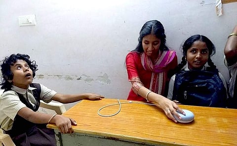 Children in one of the blind schools listening to the audio textbook