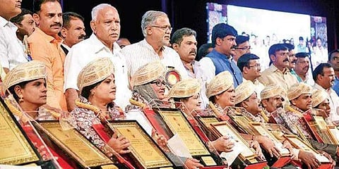CM B S Yedi- yurappa, minister Suresh Kumar and others present the Karnataka State Award to teachers, in Bengaluru on Thursday
