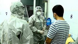 Medical personnel wearing protectice suits interact with two patients tested positive to the coronavirus  (Pic: AFP)