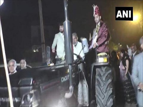 The groom driving the tractor (Pic: ANI)