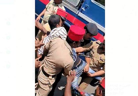 A student being dragged away by the police