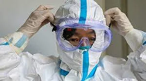A doctor in Chennai putting on their PPE