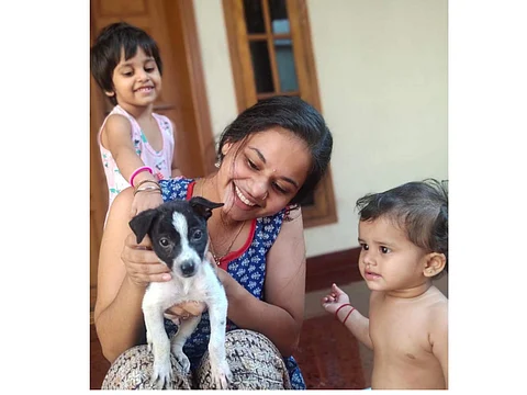 Greeshma with her daughters and Oreo