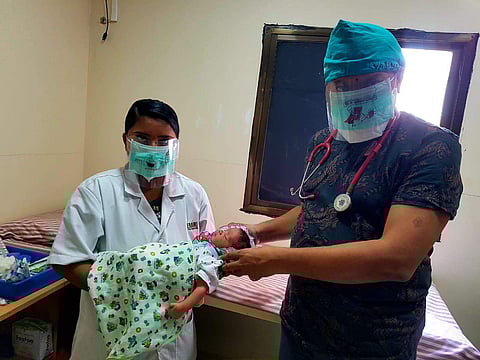 Medical staff wearing Simran's mask shields
