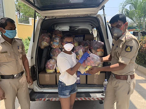 Tisya handing over the essentials to policemen