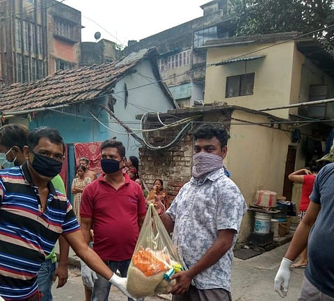 Giving out ration to the needy | Photo: Kolkata Gives