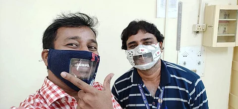 Vinod Karthavya with his friend trying out the Smile Mask