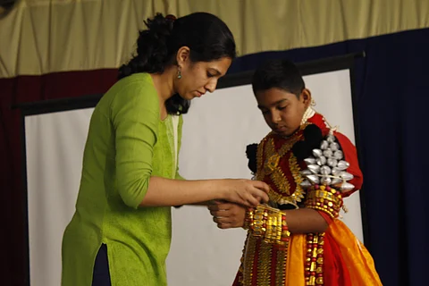 Priyanka Mohan helping her student wear a Yakshagana costume (Pics: Yaksha Degula)
