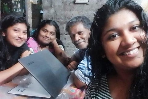 Anakha, Ardra and their parents with the laptop
