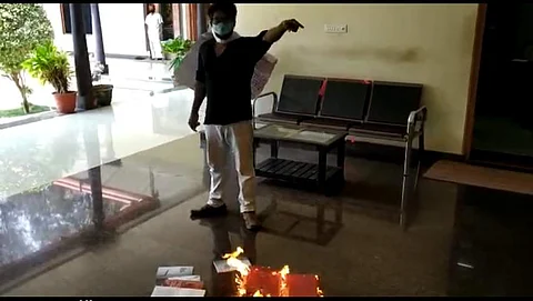 Aji burning his thesis (Pic: Facebook)