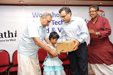 Asna Aslam receives a Plexi Talk Daisy Reader