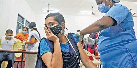 A health worker administering a dose of COVID-19 vaccine to a student at Meenakshi Sundararajan Engineering College in Chennai | R Satish Babu
