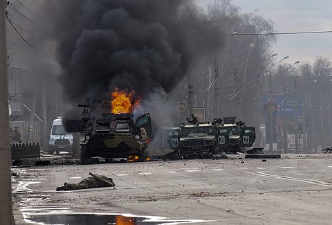 A Russian armored personnel carrier burns amid damaged and abandoned light utility vehicles after fighting in Kharkiv, Ukraine, Sunday, Feb. 27, 2022 (Pic: AP)