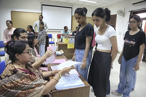 Students arrive to cast their votes for the Delhi University Students' Union (DUSU) polls at Miranda House in New Delhi. (PTI Picture)