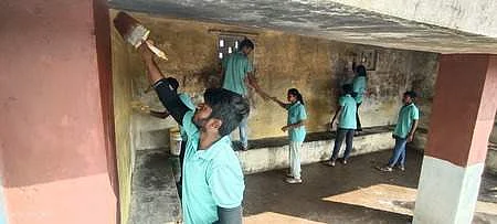 Students paint a bus stand at Anturu village near Gadag. EXPRESS Photo